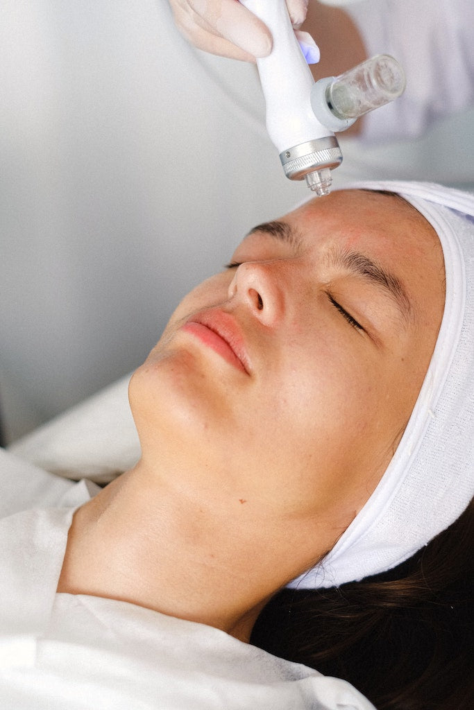 Woman receiving facial treatment
