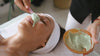 woman applying face mask to a client