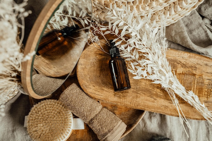 Brown glass bottles on a wooden surface with natural elements